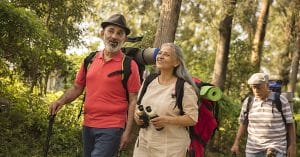 Senior citizens hiking in the woods receive valuable travel tips.