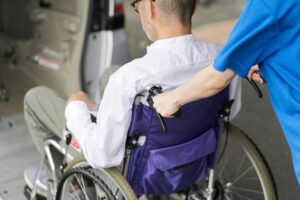 A caregiver who puts an elderly person in a long-term care taxi